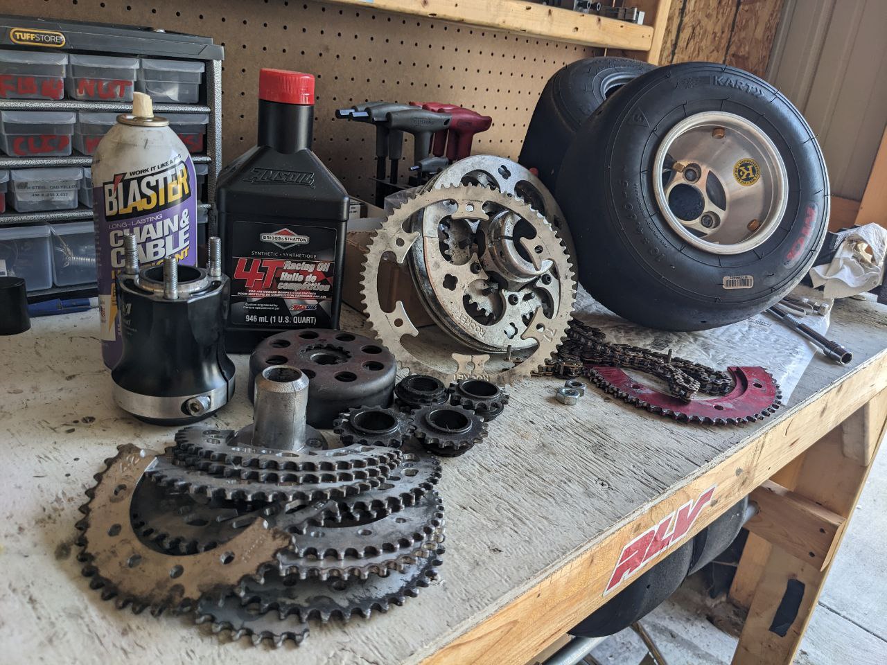 Picture of a variety of kart parts spread across a work bench